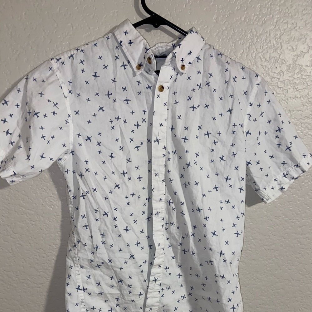 white button up shirt with blue planes